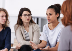 women supporting each other during psychotherapy group meeting