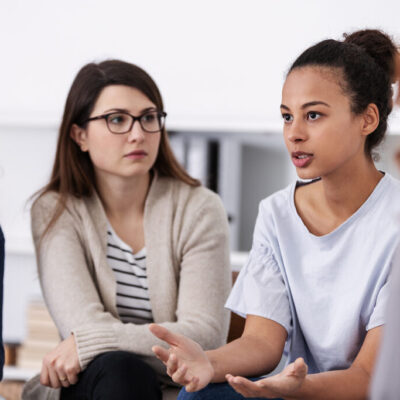 women supporting each other during psychotherapy group meeting